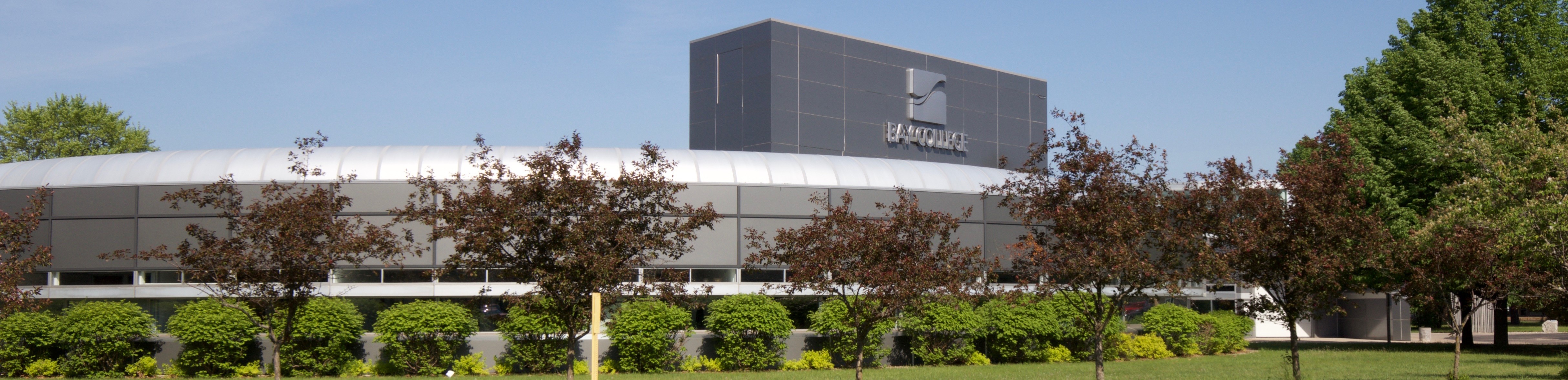 A view of Bay College's Escanaba campus showing the exterior of the Hub and Student Services buildings.